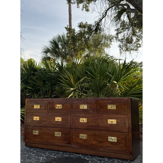 A beautifully crafted vintage Henredon campaign-style dresser, showcasing the exceptional quality and timeless design that...