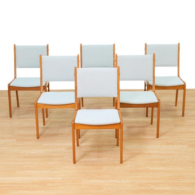 A beautifully crafted set of six Danish Modern dining chairs, showcasing the clean lines and understated elegance that...