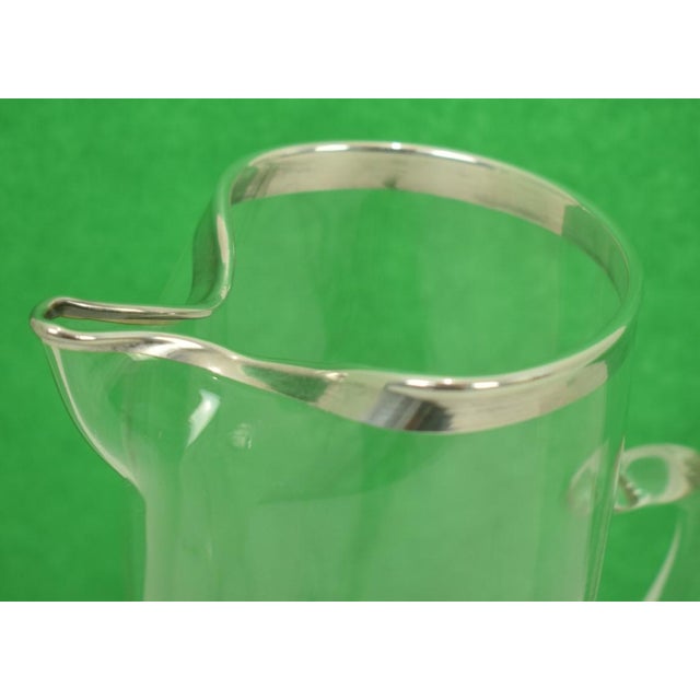 Sz: 9"H x 3 3/4"D rim x 6 1/4"L Rockwell Silver Co. Vintage mid-20th century clear glass cocktail pitcher with pinched...