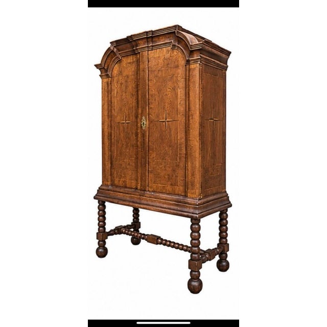 A magnificent elm veneer sideboard with a stand. The doors and sides feature a North Star marquetry pattern. The interior...