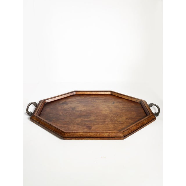 Wooden and metal tray, France, 20th century. An elegant octagonal serving tray made of wood with metal side handles. Its...