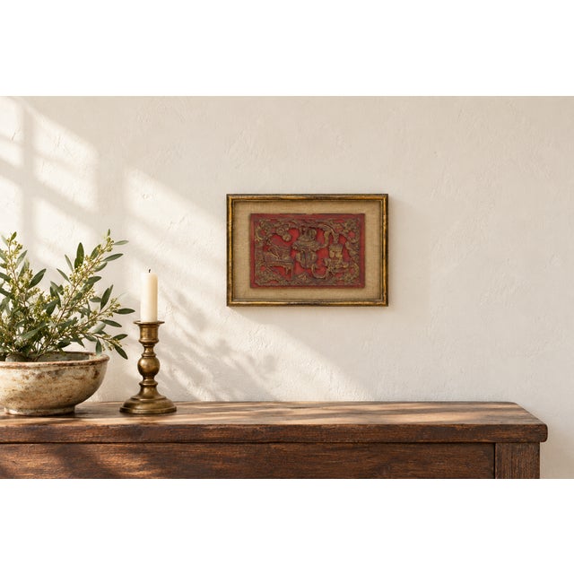 A horizontal carved panel in red and gilt on the bogu theme, the "hundred antiques" motif of treasured objects. A lidded...