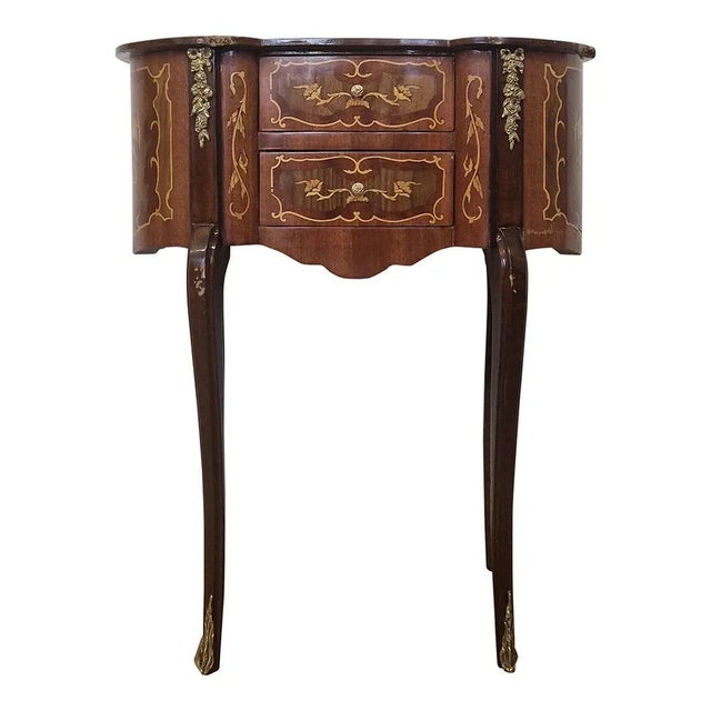 Baroque style telephone table with 2 drawers, in walnut wood and inlays; knobs and decorations in golden brass. A real...
