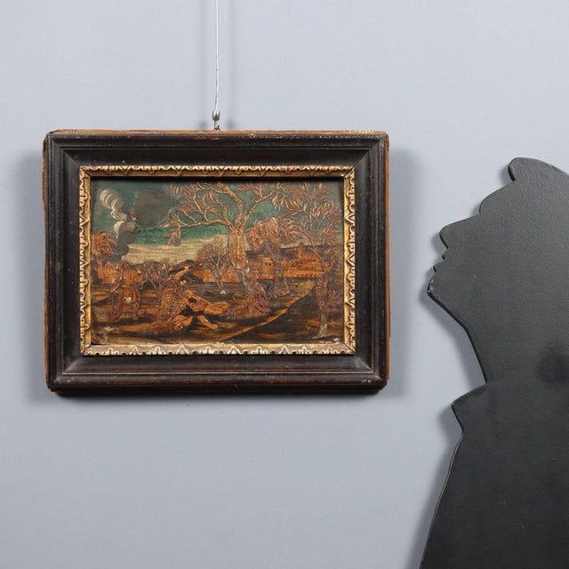 Wood inlay. The scene is set in a countryside with trees resembling olives and a city in the background; in the left...