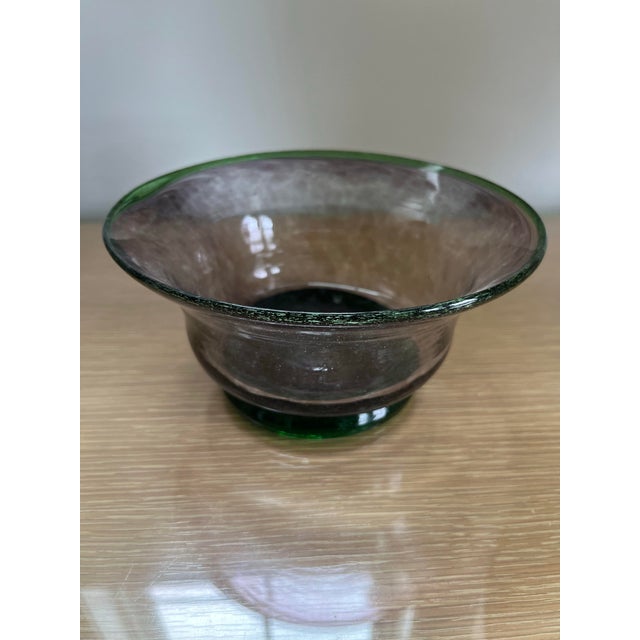 A vintage Mexican hand-blown glass bowl distinguished by its luminous purple hue and delicately applied green detailing...