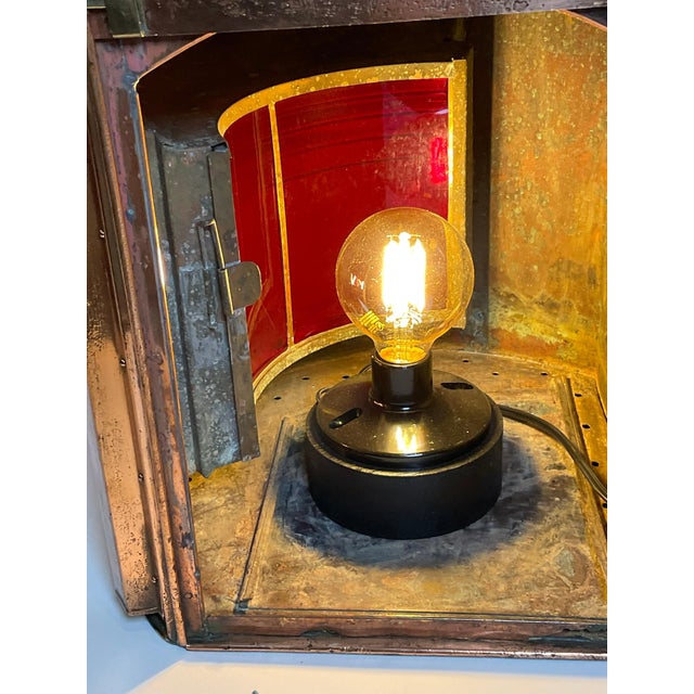 Highly polished ships side light port lantern. Copper case with heavy brass handles, hinges, lens bezel and protective...