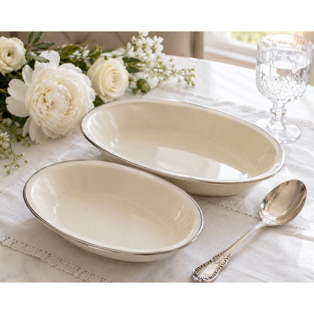 A timeless pair of vintage Lenox Montclair oval serving bowls crafted in Lenox’s signature warm ivory china and finished...