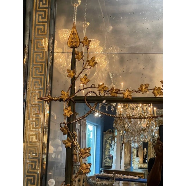 This large scale Vintage Italian Gilt Iron Mirror is a luxurious and elegant piece. Featuring an iron base with scrolling...