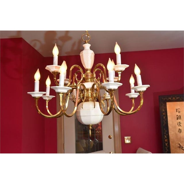 Offering for sale this lovely vintage polished brass and white porcelain/ceramic chandelier in outstanding condition and...