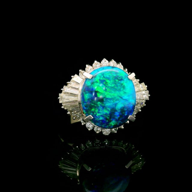 A striking black opal commands attention! It features an enchanting play of color and weighs 5.62 carats. This oval gem is...