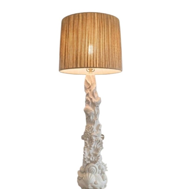 A large and very heavy coastal floor lamp with custom shade. The lamp features an amazing array of sealife, clamshells,...