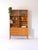 Vintage bookcase made up of two modules, the lower part is a small sideboard with door and drawers, while the upper part...