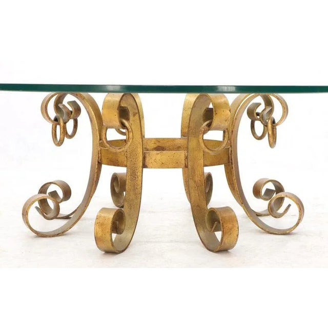 Mid-Century Modern Hollywood Regency iron base glass top round coffee table.