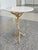 This contemporary cocktail table harkens back to classic Hollywood Regency. It consists of a round, white quartz top and a...