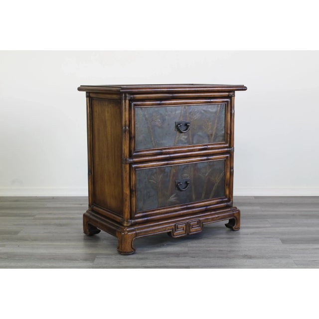 Vintage Asian style commode of two drawers with brass etched panels on drawers and the top, The panels have a foliage...