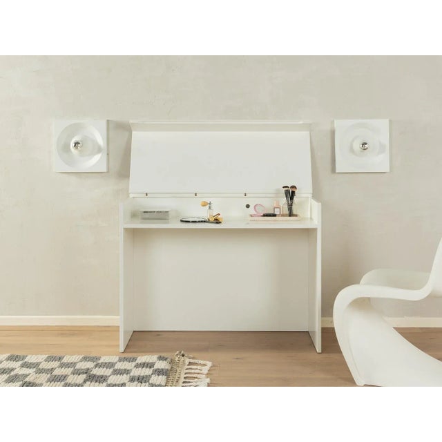 Wonderful desk from the 1970s. Body made of white lacquered wood and a folding work surface. Handcrafted by a carpenter....