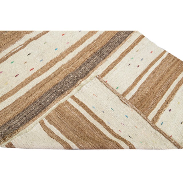 Beautiful vintage Turkish Kilim flatweave wool runner with a beige field. This rug has multi-color accents in a gorgeous...