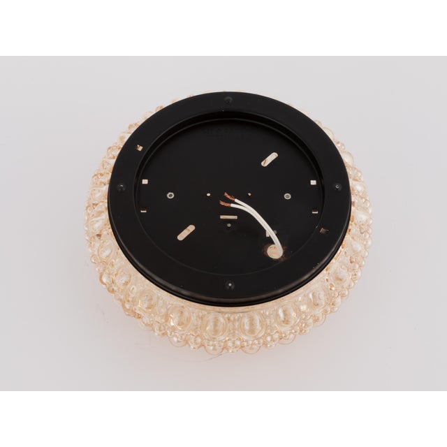 Beautiful flush mount designed by Helena Tynell for Glashutte Limburg, Germany. The lamp has a amber glass shade, and a...