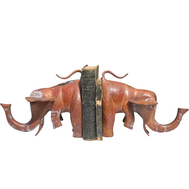 Striking pair of vintage metal elephant bookends from India, featuring oversized sculptural forms with dramatically...