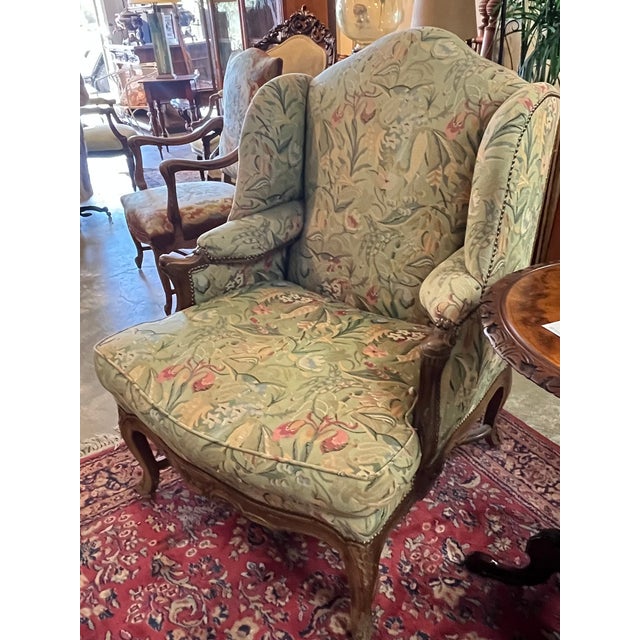 Pair of French Walnut Bergere Wingback Chairs,all down filled and nicely upholstered in floral upholstery. 30" W × 35" D ×...