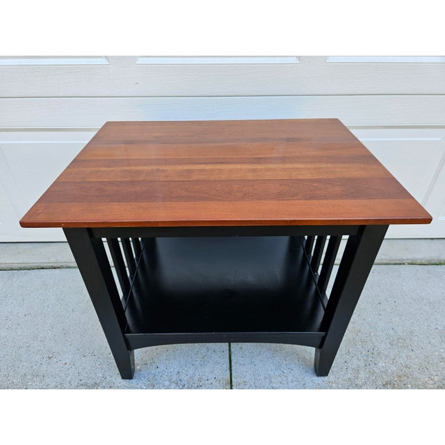 This great looking Arts & Crafts or Mission style side table features a cherry top and black lacquered base with lower...