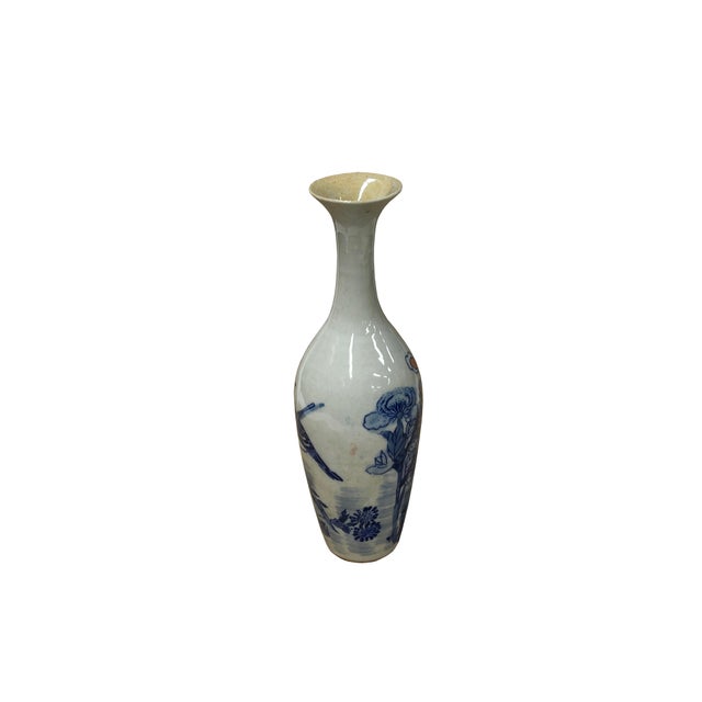 This elegant porcelain vase features a slender, elongated neck that flares into a delicate trumpet mouth, balanced by a...