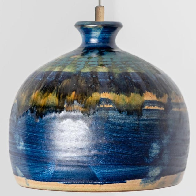 Stunning small round hanging lamp with a bowl-like shape, made with rich aqua-colored cobalt and yellow ceramics,...