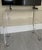 Custom-fabricated clear acrylic waterfall media console on smooth-rolling chrome casters. Engineered from premium, ultra-...