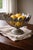 A sculptural silverplate centerpiece bowl crafted from 24 vintage teaspoons arranged in a dramatic radial form. Mounted on...