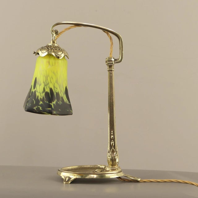 Art Deco table lamp by Charles Ranc, ca. 1910-1915, signed. Lampshade made of flashed glass, Nancy, France. The lamp gives...