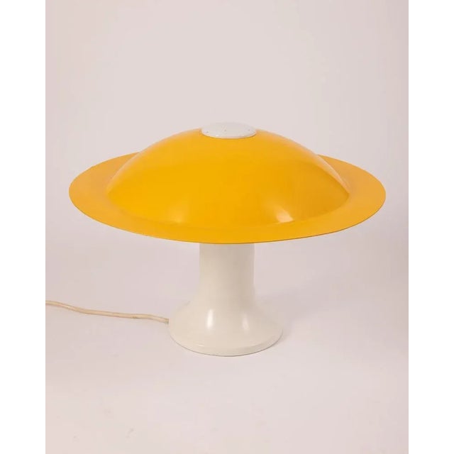 Three -light table lamp with white metal body and yellow lampshade, Martinelli design, 70s. Conditions: in good condition,...