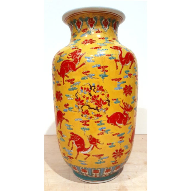 Chinese porcelain Famille Rose Qilin vase, imperial yellow glaze with faint light brown highlights on the body and the...