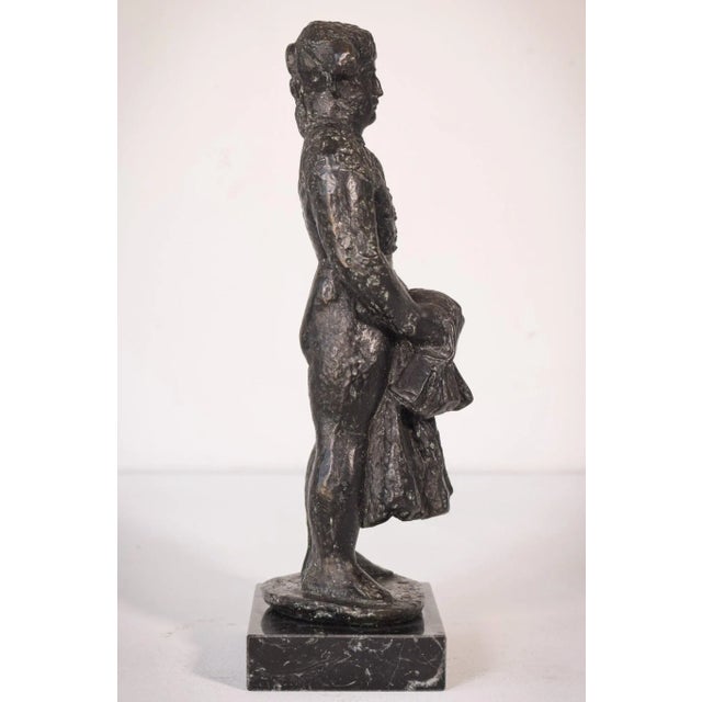 An imposing depiction of a matador (bullfighter) with a powerful stance, this broad figure has a stern facial expression...