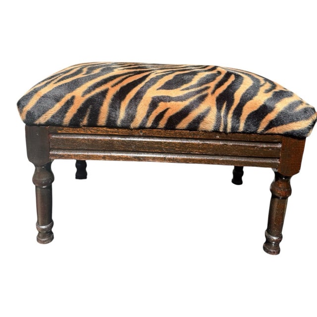 Elegant 1920s English Regency Revival footstool crafted from solid mahogany. The piece features finely turned tapered legs...