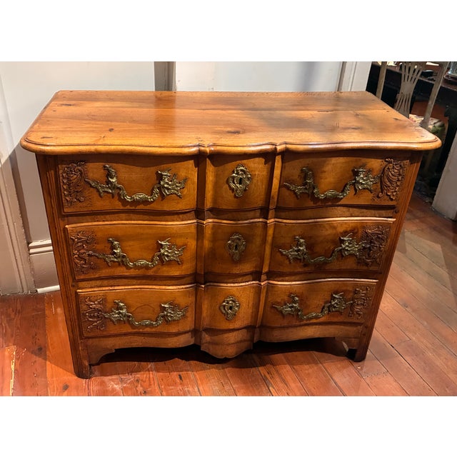 A Rococo style three-drawer-commode, 18th c. commode with a crossbow form front (en arbelete) and in a light colored, rich...