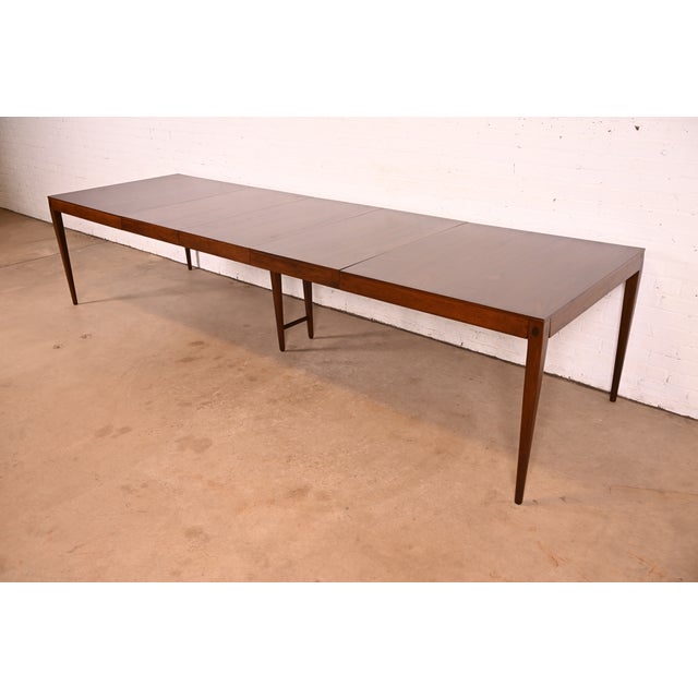An exceptional Mid-Century Modern sculpted walnut extension dining table By Kipp Stewart for Directional and produced by...