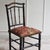A bamboo-effect chair from around 1880, crafted in the style of the French Napoleon III, with a black-painted frame and...
