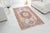 This is a vintage Turkish Oushak rug from the Mid 20th Century. The piece was hand-knotted.