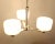 This 3-Light Brushed Nickel Chandelier features round frosted glass globes for a modern look. The adjustable post...