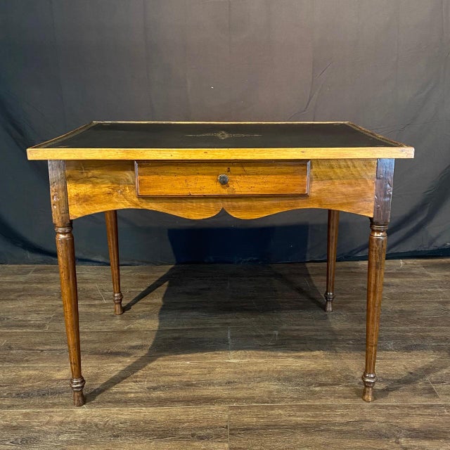 This elegant French leather-top game table reflects the refined craftsmanship and understated luxury of 19th-century...