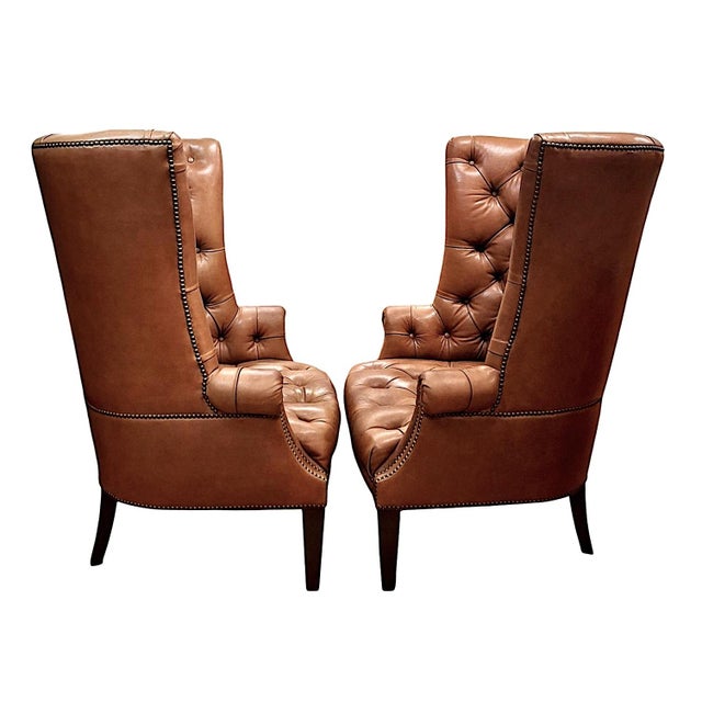 On offer is a pair of high-quality Chesterfield-style barrel back armchairs that recall quiet English evenings by the fire...