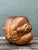 This evocative hand-carved wood sculpture presents a compelling interpretation of the traditional "crouching yogi" or...