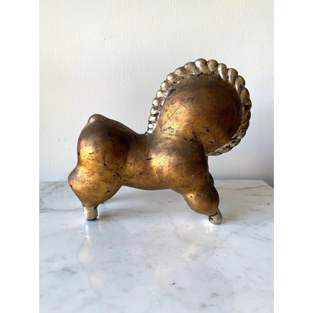 This Mid-Century Modern Italian Ceramic Libbiloo Gold & Silver Horse Sculpture pays homage to the iconic design...