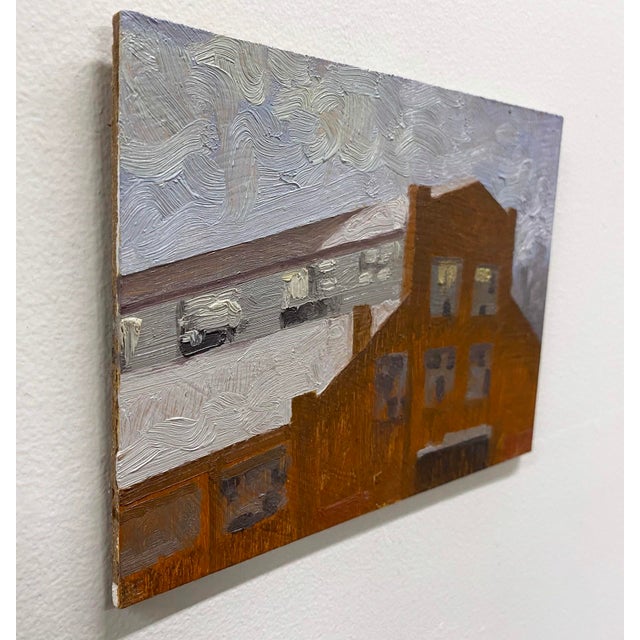 This oil on panel work depicts a weathered bell factory, its rustic facade bathed in warm earthy tones that contrast with...