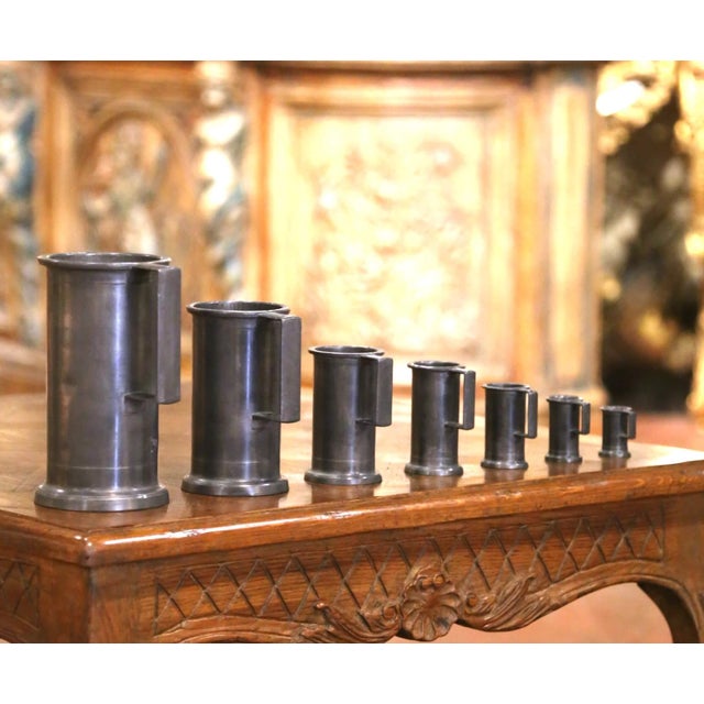 This handsome set of seven vintage French pewter measures combines utilitarian design with strong sculptural appeal....