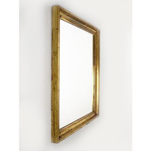 20th-century French wall mirror with a molded wooden frame entirely gilded with gold leaf. The gilding has a superb...