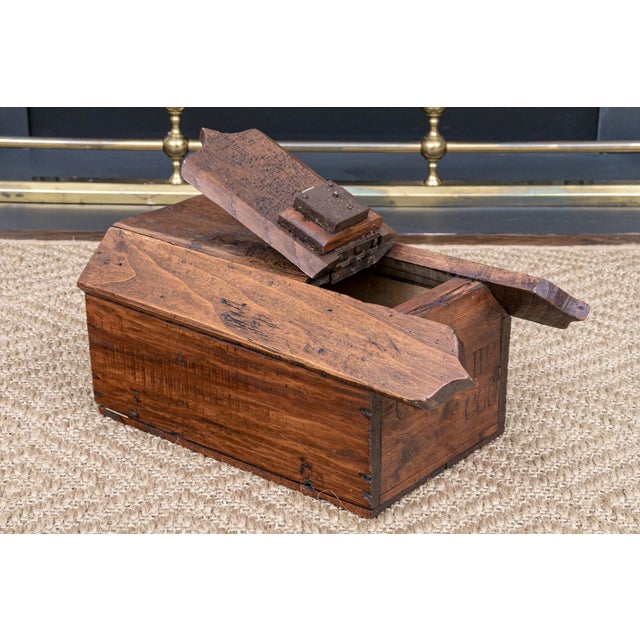 A rustic antique oak ballot box with heavily weathered patina, a shaped, scalloped-edge hinged lid, ballot slot and...