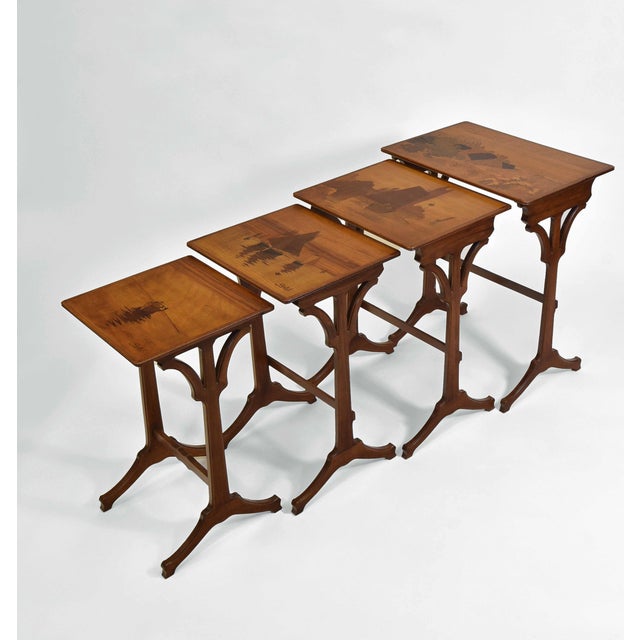 Superb French Art Nouveau nest of tables with graduated tops, having specimen wood inlays with nautical themes of...