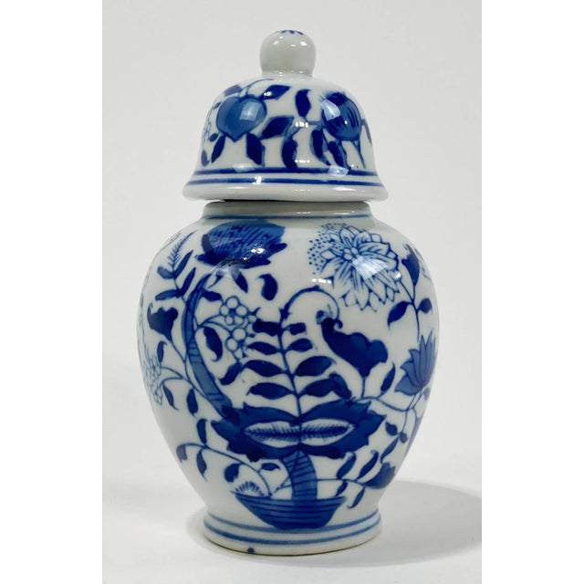 Vintage petite lidded blue and white floral motif temple jar. Marked Formalities by Baum Brothers. Age wear. No chips or...