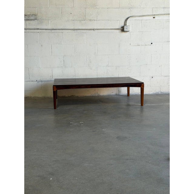 Striking large Danish Mid-Century Modern coffee table, crafted from richly figured rosewood. The expansive tabletop...